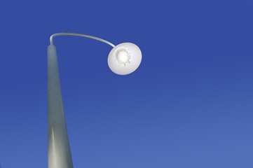 Street lamp against blue sky