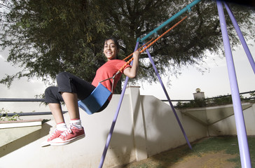 girl swings in park