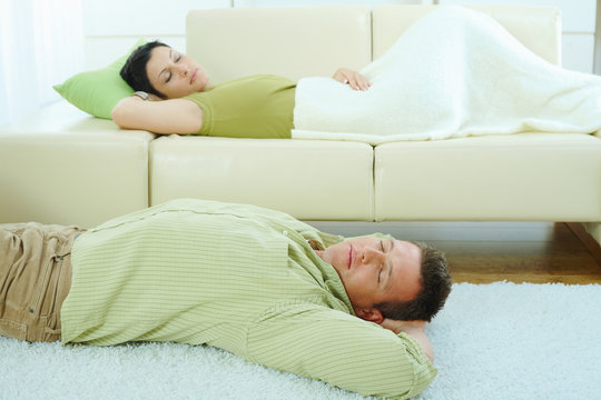 Couple sleeping on couch