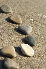 Stones on sand at the sea, a pebble