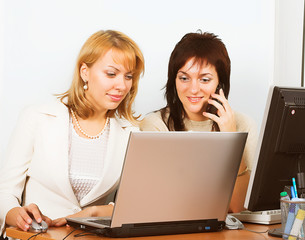 Two Young business woman working on laptop