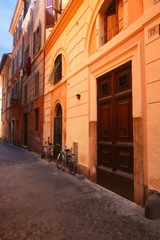 Fototapeta na wymiar Bicycles on street in front of Buildings Rome Italy