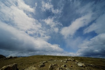 Sky meets rocky hilltop