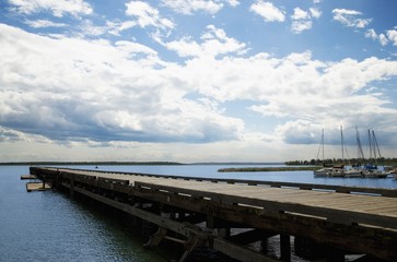 Fototapeta na wymiar Pier overlooking sailboats and lake