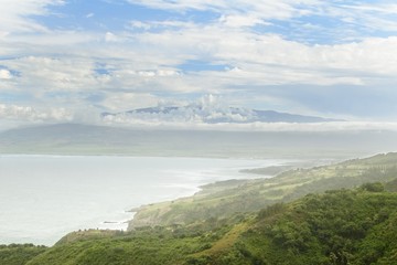 Fototapeta premium Distant view of Maui's Haleakala crater with white clouds in Hawaii, USA..