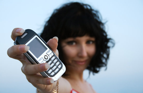 Young Woman Holding Out A Mobile Phone