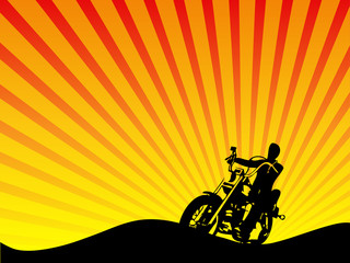 Motorcycle Rider Silhouette Against Sunset Background