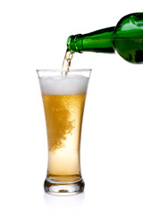 Beer being pour on a glass over a white background