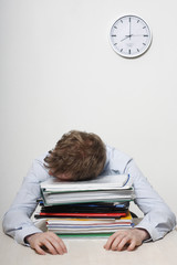 Business man sleeping on a pile of work