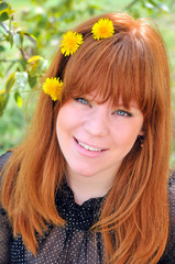 Naklejka premium Beauty Redheaded Girl With Dandelions In Her Hair