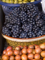 Baskets of grapes and other fruit