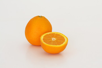 One and a half oranges on a white background.