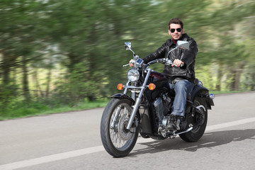 Fototapeta na wymiar Young Rider Driving Motorcycle