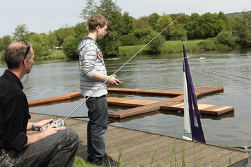 Father and son with remote controls