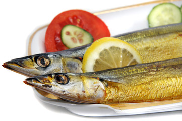 herring with tomato, cucumber and lemon on the dish