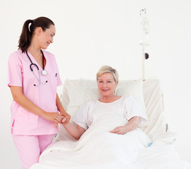 Nurse measuring a patient's pulse