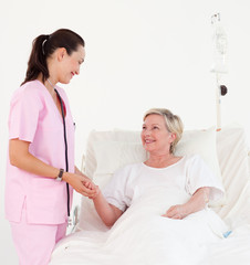 Elderly woman lying in hospital bed