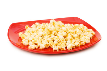 Popcorn on red plate isolated on white