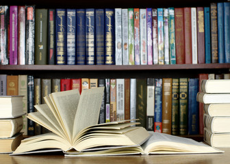 Opened books on desk in library