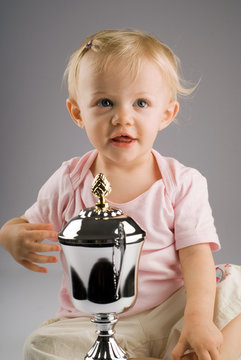 Baby Girl With Silver Trophy