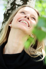 Naklejka premium Russian beauty - the happy girl at a white birch