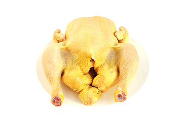 Raw chicken on the plate isolated over white with clipping path. © luckyli