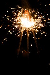 Obraz premium yellow sparkler with fire particles