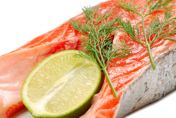 fresh salmon steak with lime slice on white background