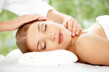 Young beautiful and relaxed lady taking spa treatment