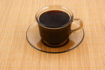 Glass cup of coffee on wooden background