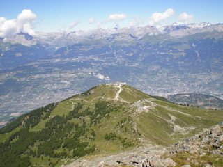 view of the alps and of a valley from a swiss mountain