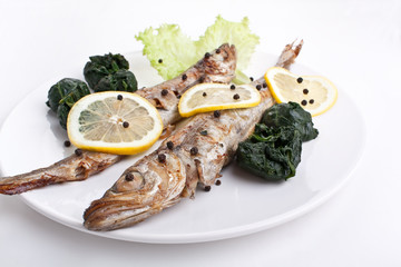 serving of grilled fish with spinach