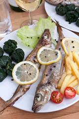 serving of grilled fish with spinach