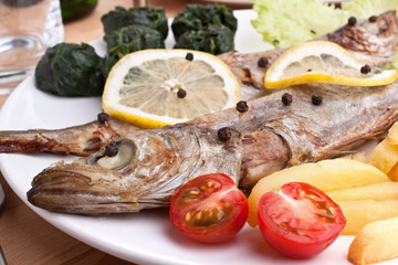 serving of grilled fish with spinach