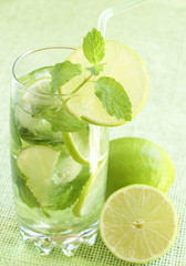 Mojito cocktail on green background