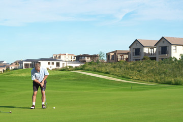 Fototapeta na wymiar Senior golfer playing golf