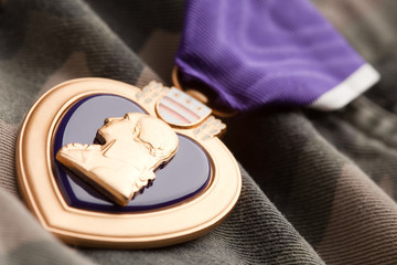 Obraz na płótnie Canvas Purple Heart War Medal on Camouflage Material
