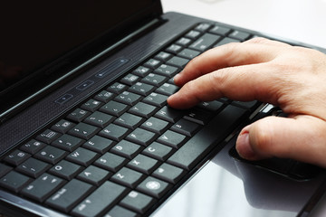 Typing on a laptop computer
