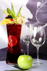 alcoholic cocktail with strawberry and piece of pineapple