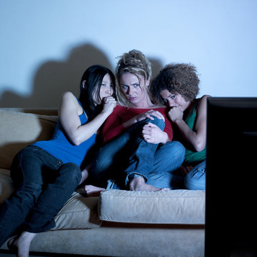 femmes terrifiées devant la tv