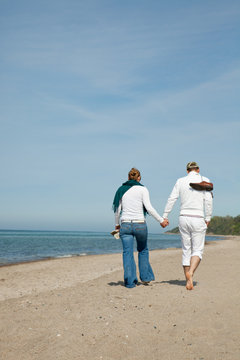 pair couple walking beach together