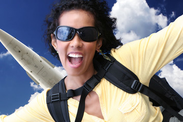 Excited young woman jumping out of plane