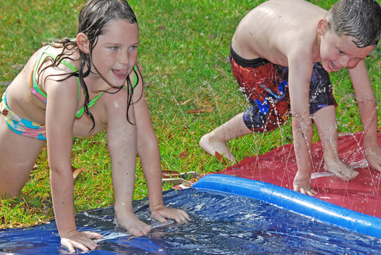 Brother and sister in water play