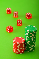Casino chips and dice against green background
