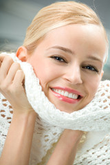 Portrait of beautiful young smiling woman with scarf