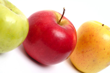 three multicolored apples in a row
