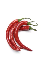 Fotobehang Three hot red chili peppers, isolated on white background © Mee Ting