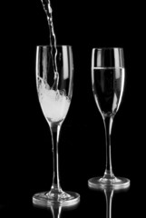 Sparkling wine poured into champagne flutes