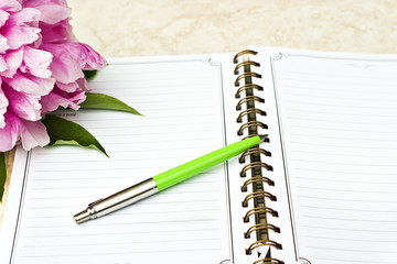 Peony on note book with ink pen