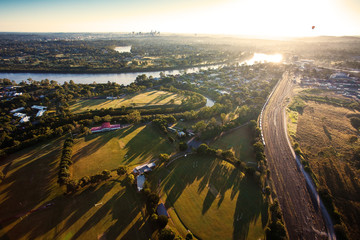 Sunshine over early morning in Brisbane from air - obrazy, fototapety, plakaty